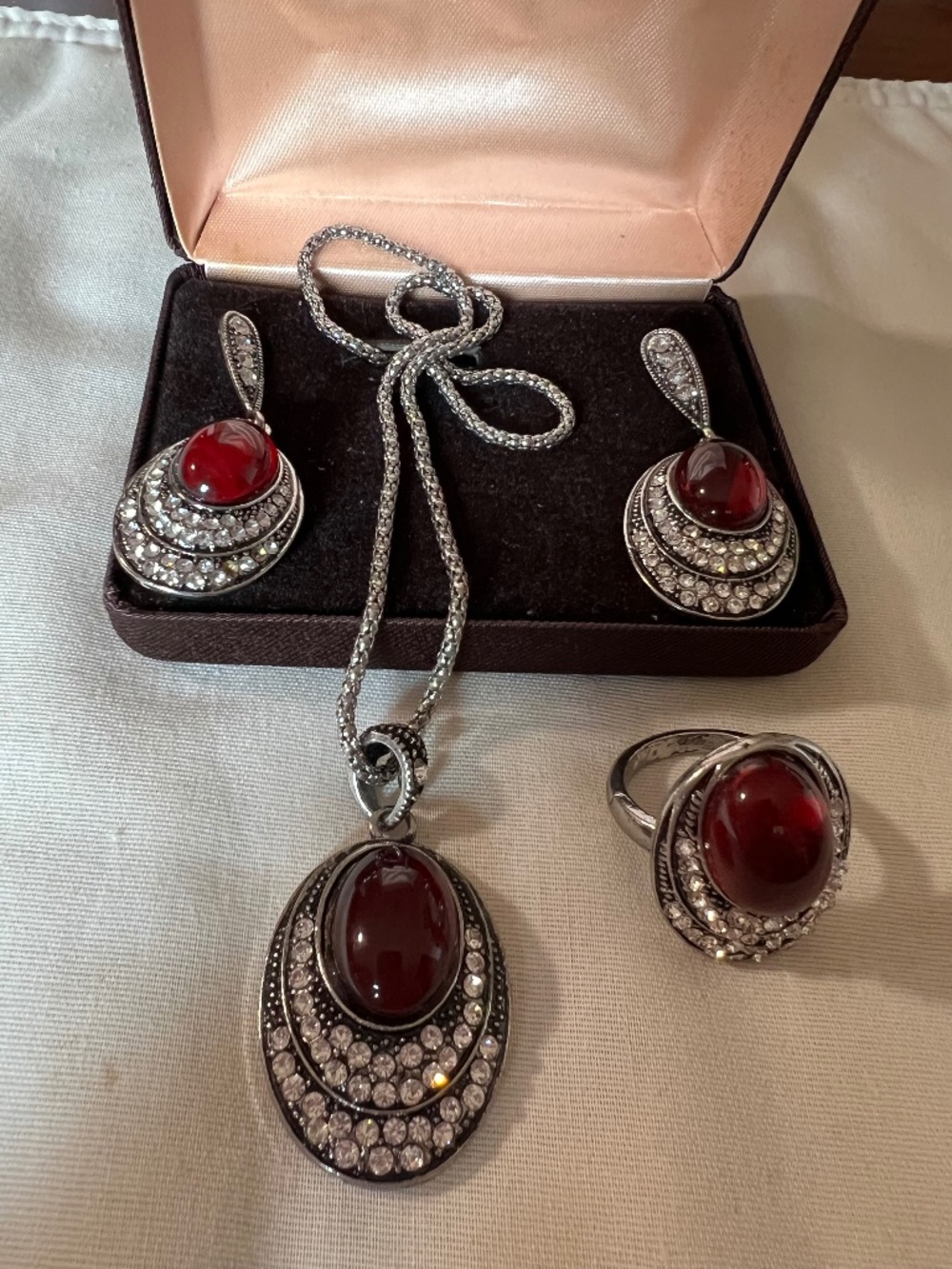 Silver tone matching jewelry set and burgundy